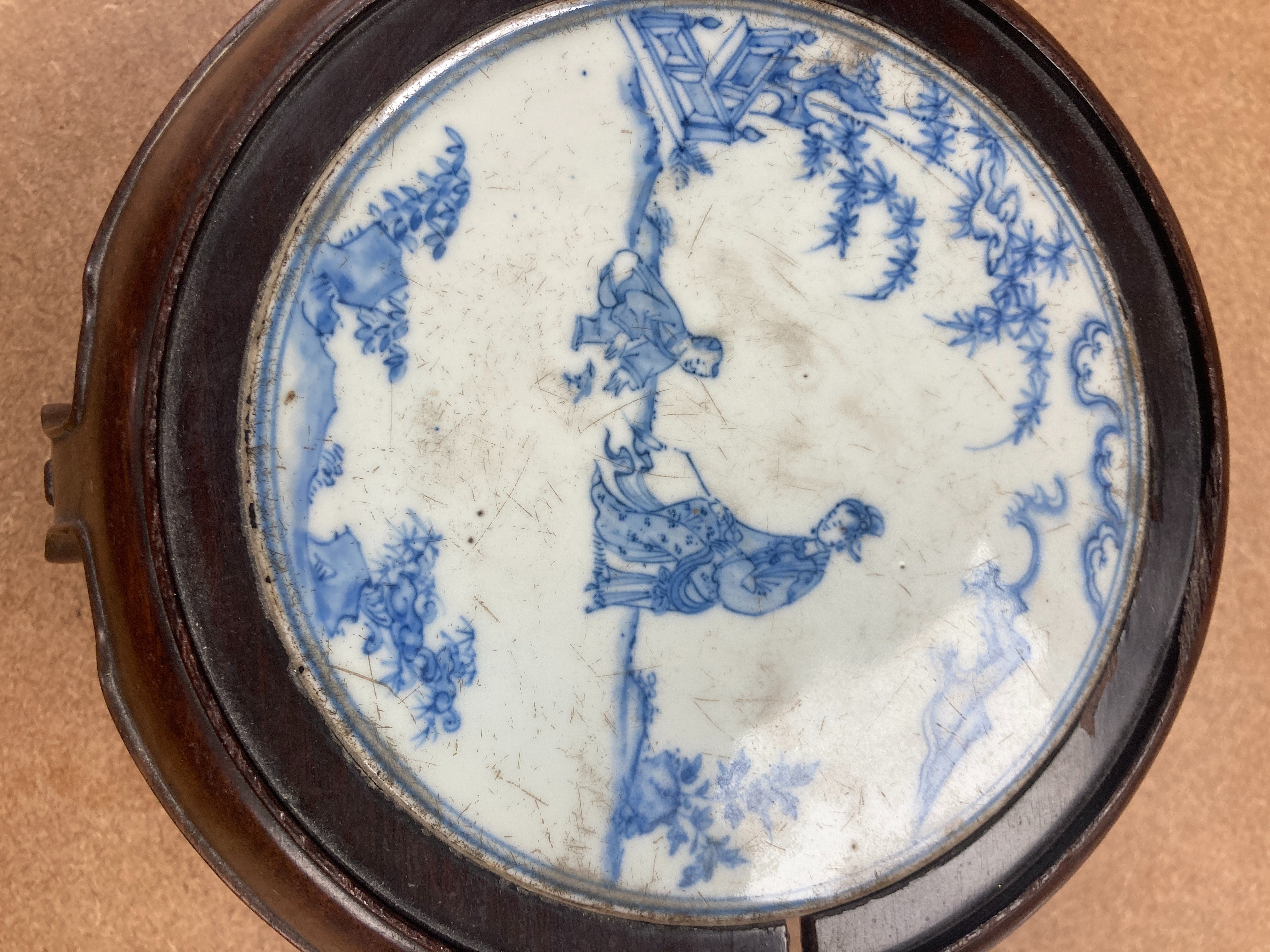 A 19th century Chinese blue and white circular tile inset hongmu stand, 22cm